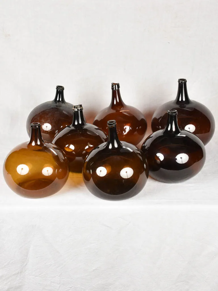 Rare collection of 9 blown glass demijohn bottles 12¼" - 22¾"