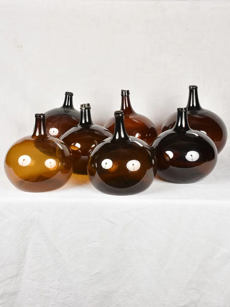 Rare collection of 9 blown glass demijohn bottles 12¼" - 22¾"